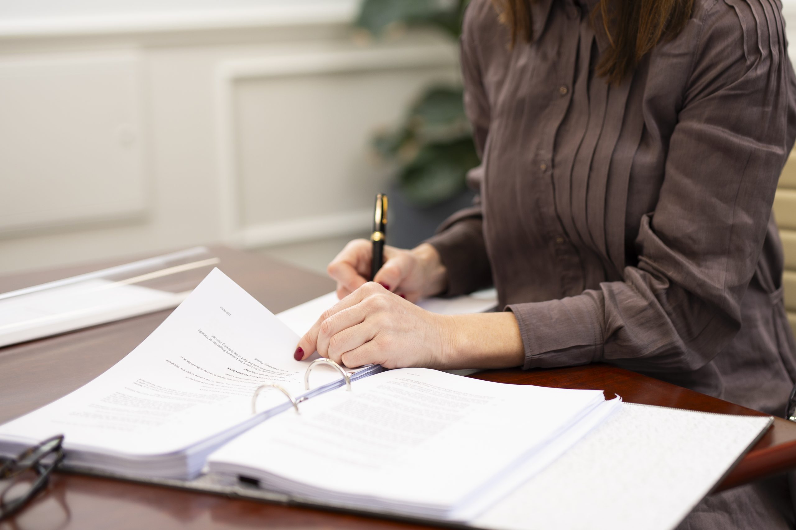 Lady holding a legal document for estate planning blog post