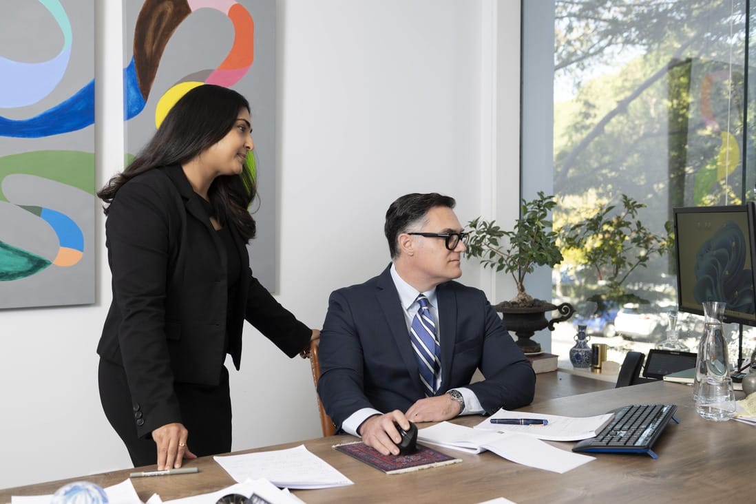 Two lawyers having a discussion at Solomon Hollett Lawyers office